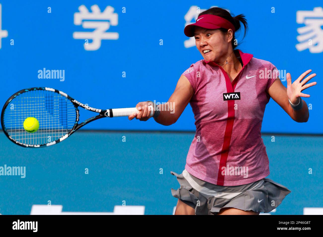 FILE--Li Na of China prepares for a return to Peng Shuai of China in their womens singles final of the WTA 2014 Shenzhen Open tennis tournament in Shenzhen city, south Chinas Guangdong