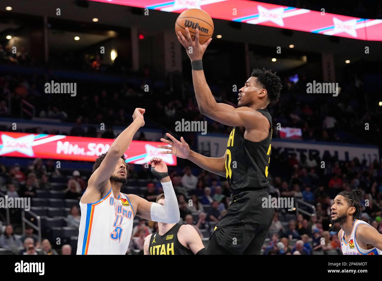 Utah Jazz guard Ochai Agbaji, right, shoots over Oklahoma City Thunder ...