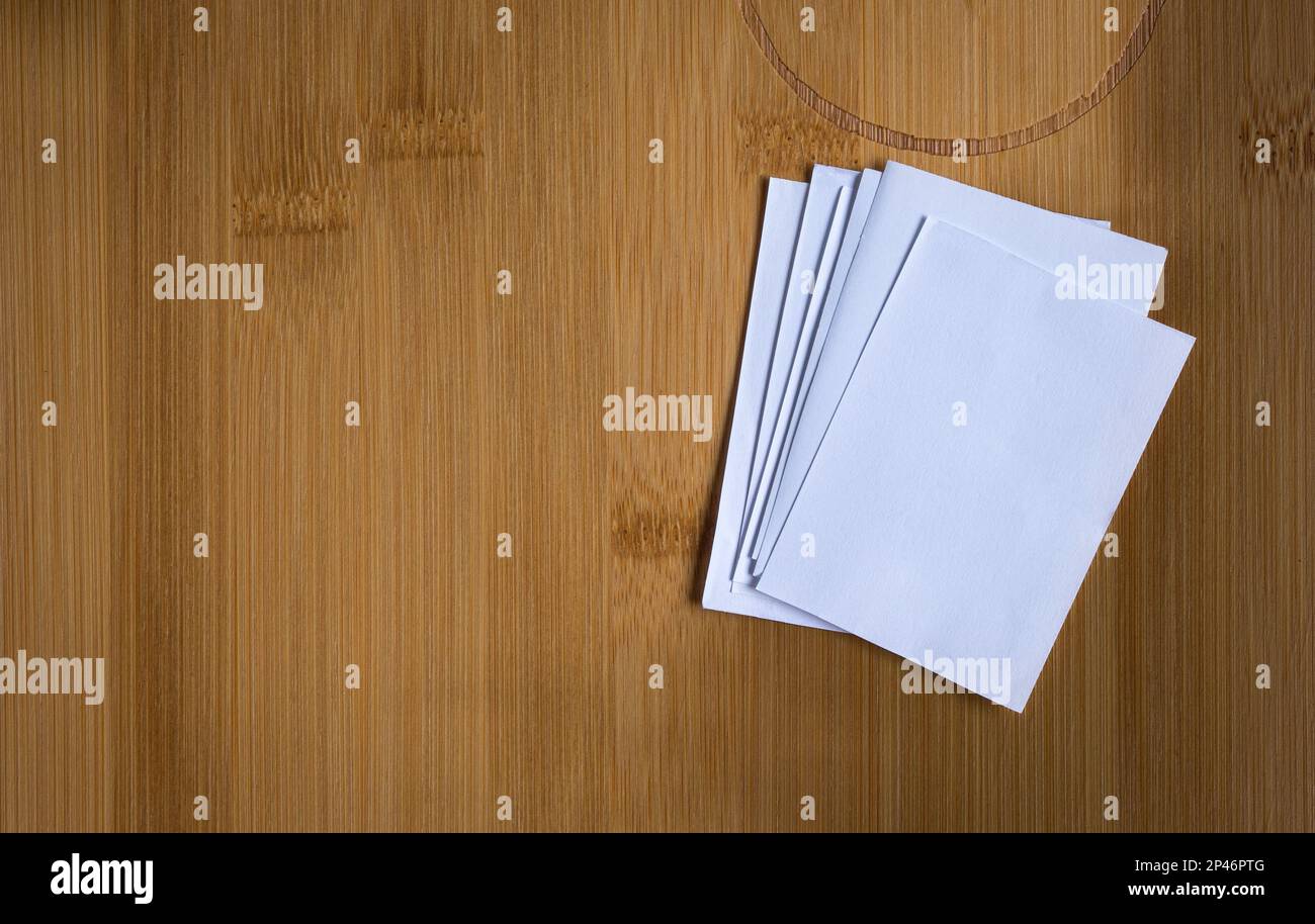 Stack of blank white papers on wooden background. Copy space. Stock Photo