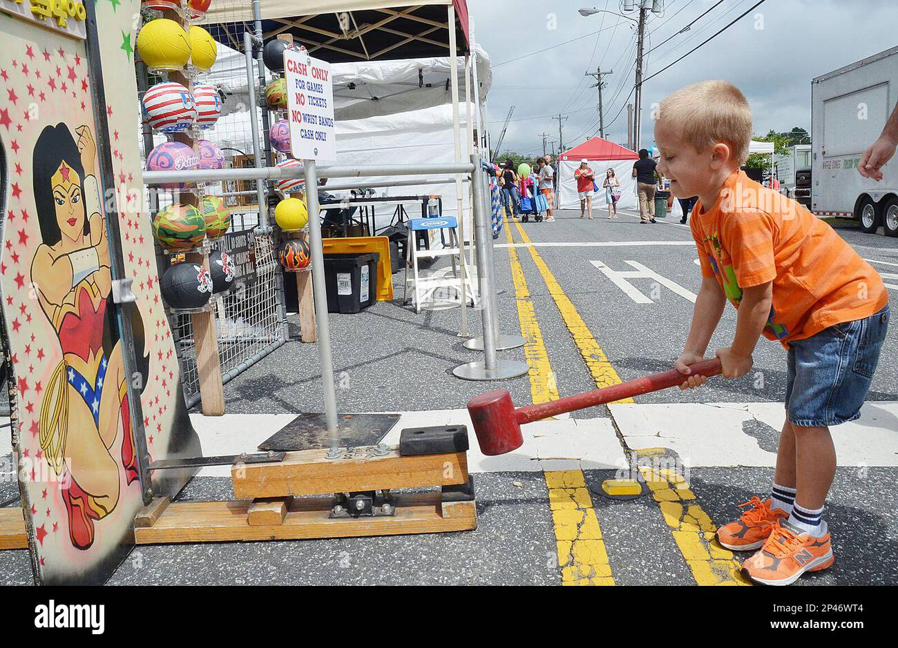 Aiden Maxwell, 5, swings a hammer as he tries to ring the bell, one of