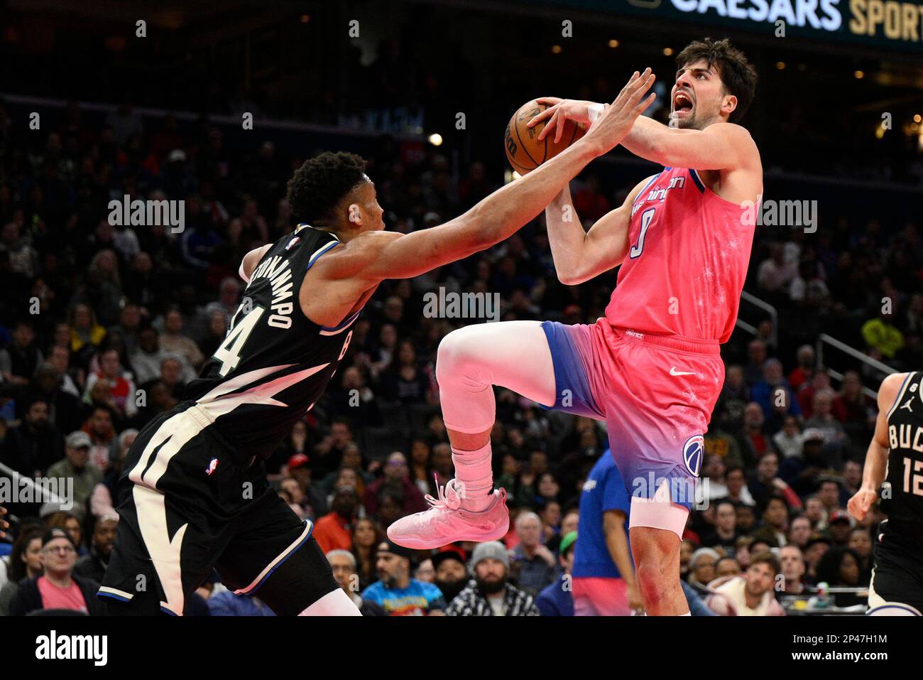 Washington Wizards forward Deni Avdija goes to the basket against Milwaukee Bucks forward Giannis Antetokounmpo during the second half of an NBA basketball game, Sunday, March 5, 2023, in Washington. The Bucks won 117-111. (AP Photo/Nick Wass) Stock Photo