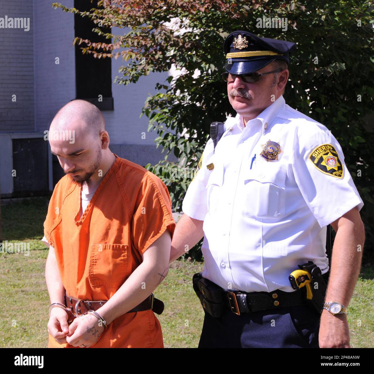 Elyette Barbour, left, is escorted from the Northumberland County