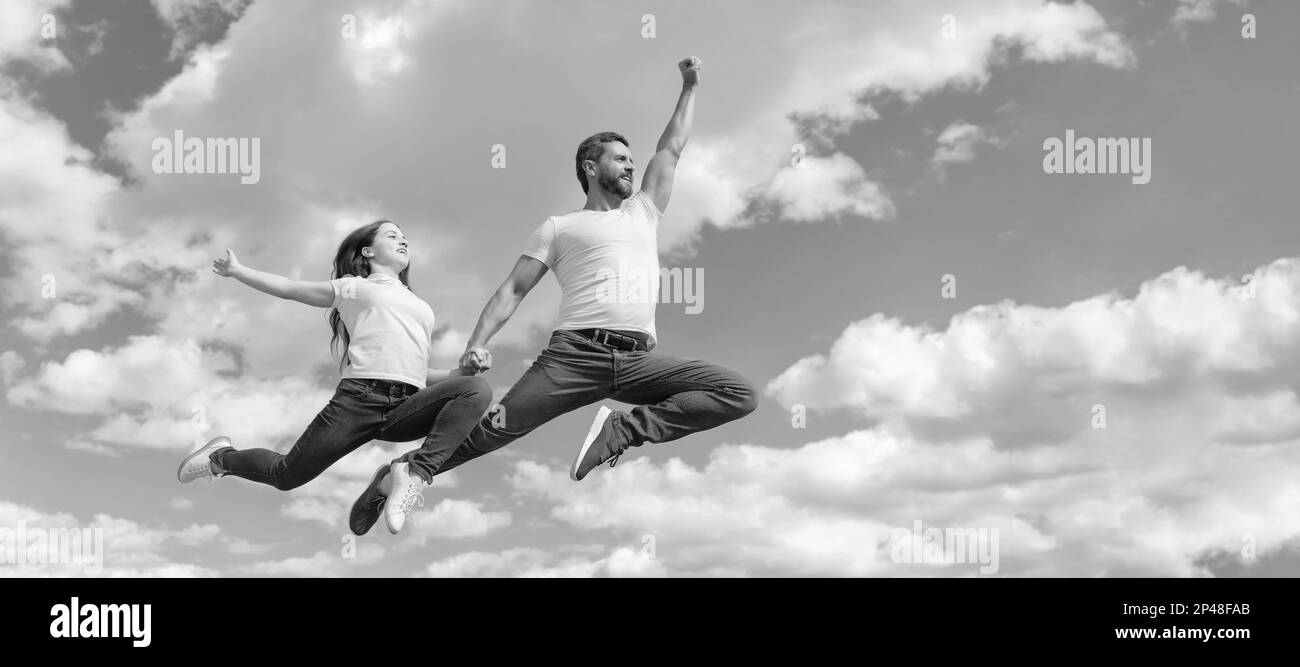 Father and daughter jump on sky, banner with copy space. happy father ...