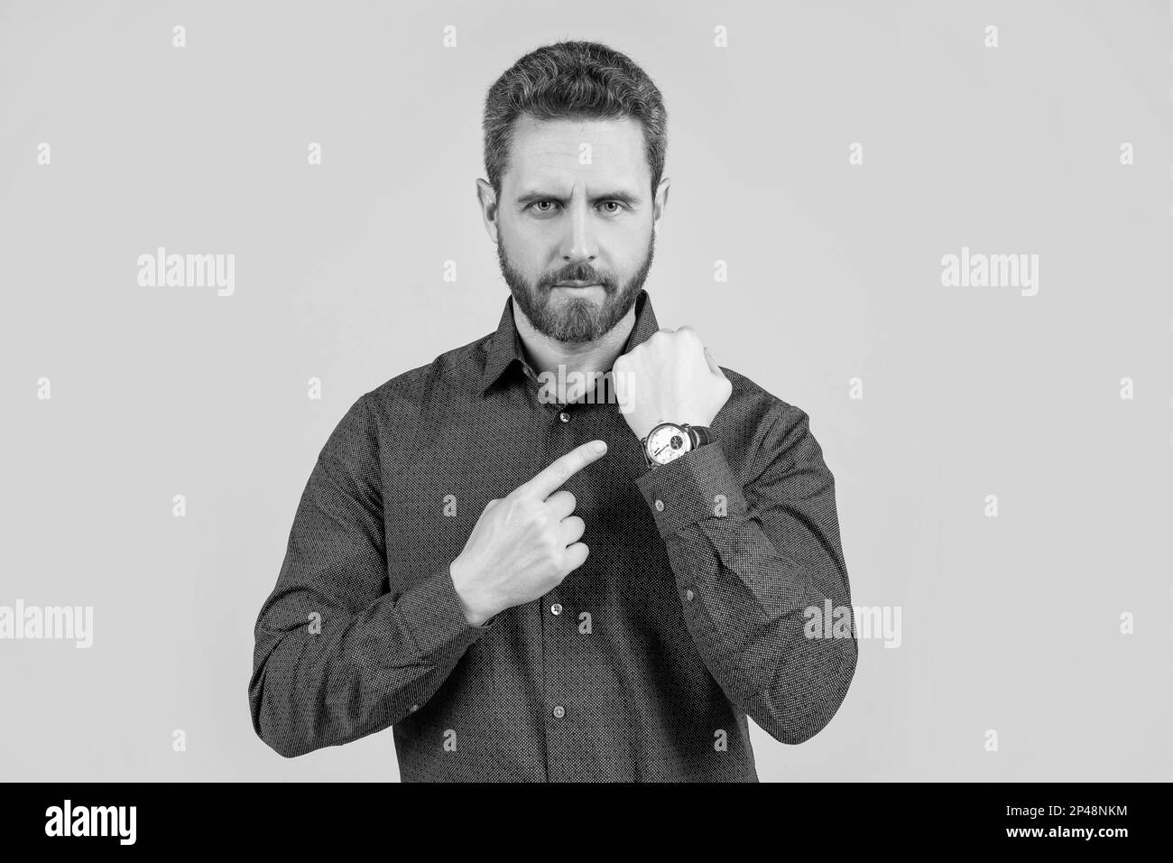 The elegance of punctuality. Bearded man point at wristwatch. Punctuality concept. Business time. Deadline. Timekeeping. Accurate time, accurate watch Stock Photo