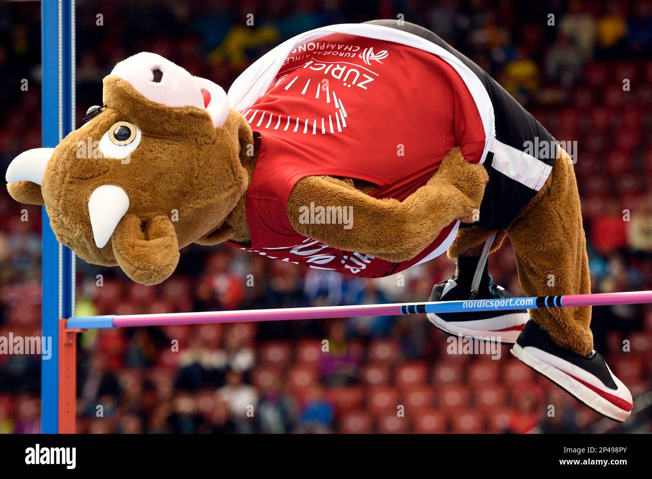 "Cooly", the mascot of the European Athletics Championships 2014, does high jump, at the third day of the European Athletics Championships in the Letzigrund Stadium in Zurich, Switzerland, Thursday, Aug. 14, 2014. (AP Photo/Keystone, Ennio Leanza) Stock Photo