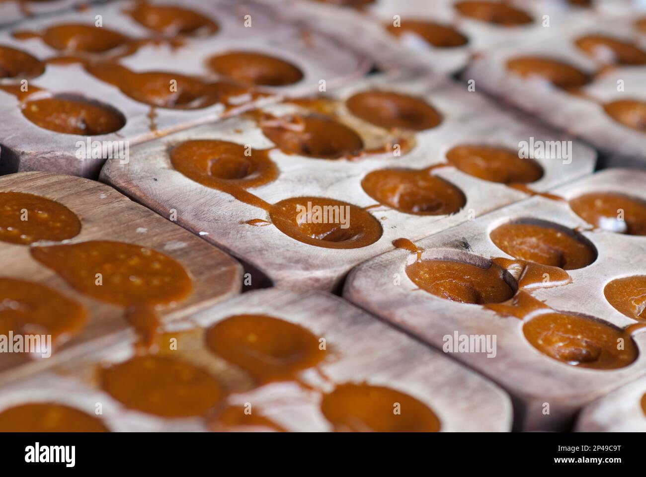 Palm sugar in wooden trays, Palm sugar factory, near Sukamade, East Java, Indonesia Stock Photo