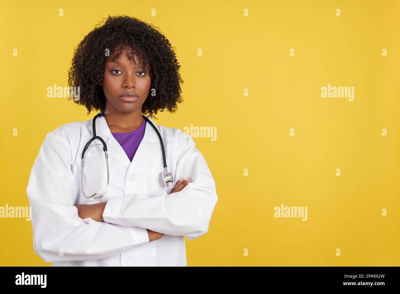 Serious afro doctor with stethoscope looking at camera Stock Photo