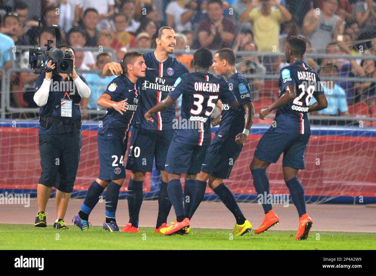 Zlatan Ibrahimovic of Paris Saint-Germain club, center, celebrates with teammates after scoring a penalty kick during the season-opening Champions Trophy soccer match against Guingamp football club in Beijing, China, 2