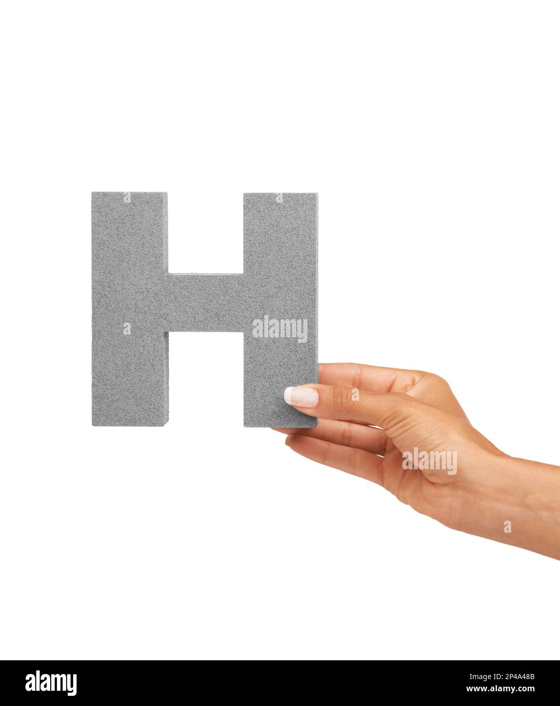 Learn your letters H. A young woman holding a capital letter H isolated on a white background. Stock Photo