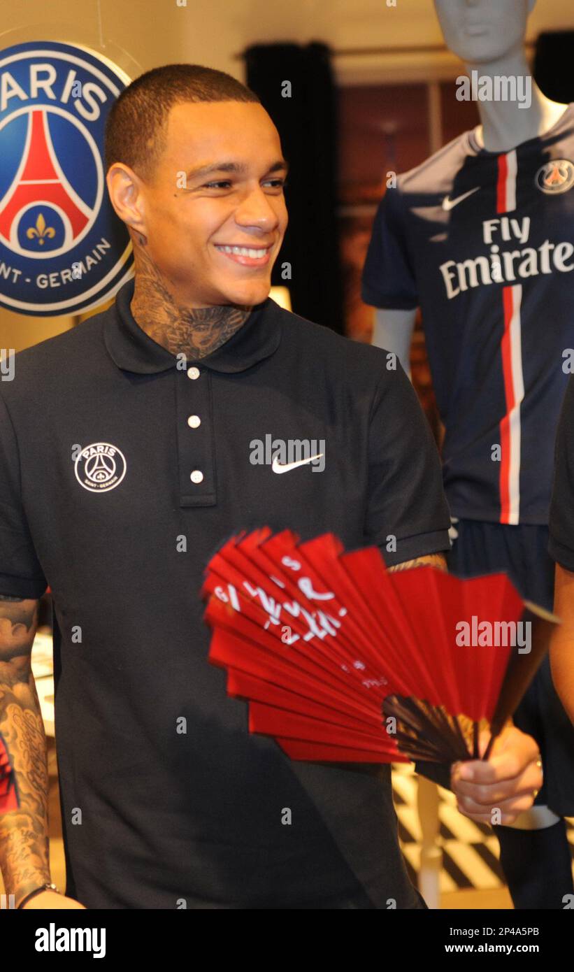 Gregory van der Wiel, left, and Marquinhos of Paris Saint-Germain football  club prepare to cut the ribbon during the opening ceremony for the Pop up S  Stock Photo - Alamy