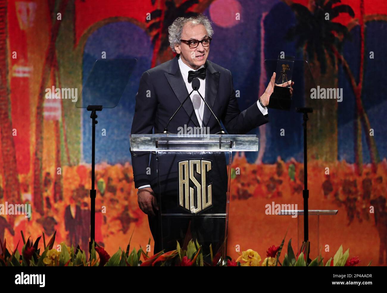 Darius Khondji accepts the 'International Award' onstage during the