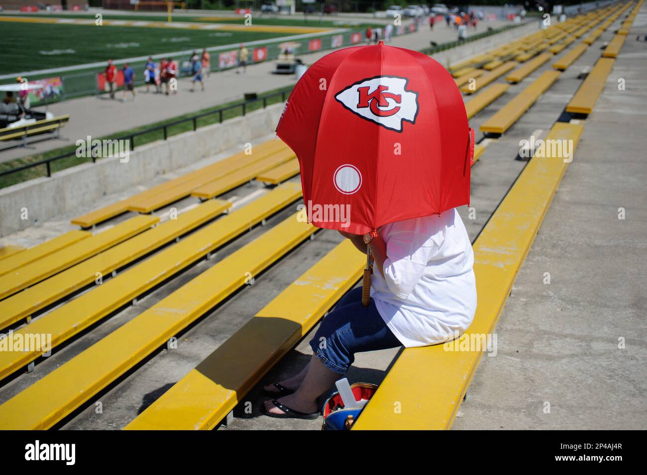 chiegs football patio umbrella A fan with a helmet-shaped umbrella sits on the bleachers at Spratt Stadium  before a Kansas City Chiefs NFL football training camp practice on the  Missouri Western State University campus in St
