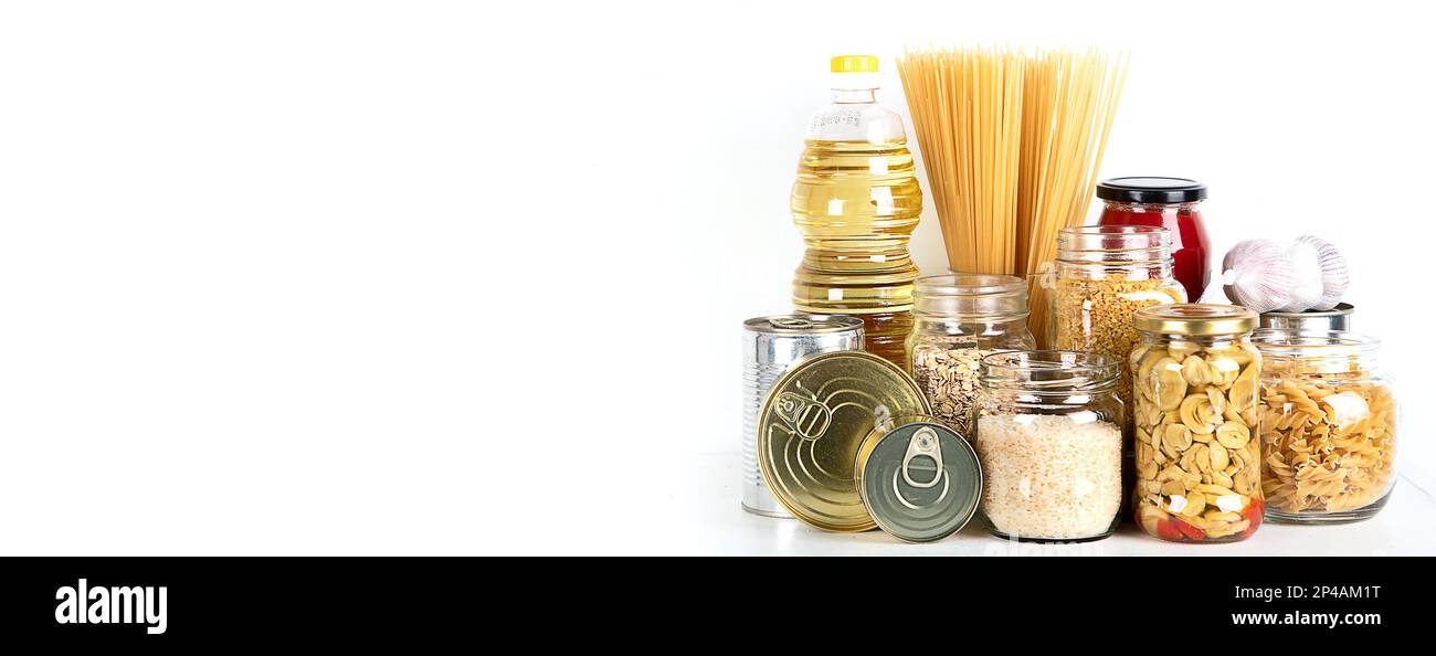 Food supplies. Crisis food stock. Different glass jars with grains, pasta, oil, nut, canned food, copy space Stock Photo