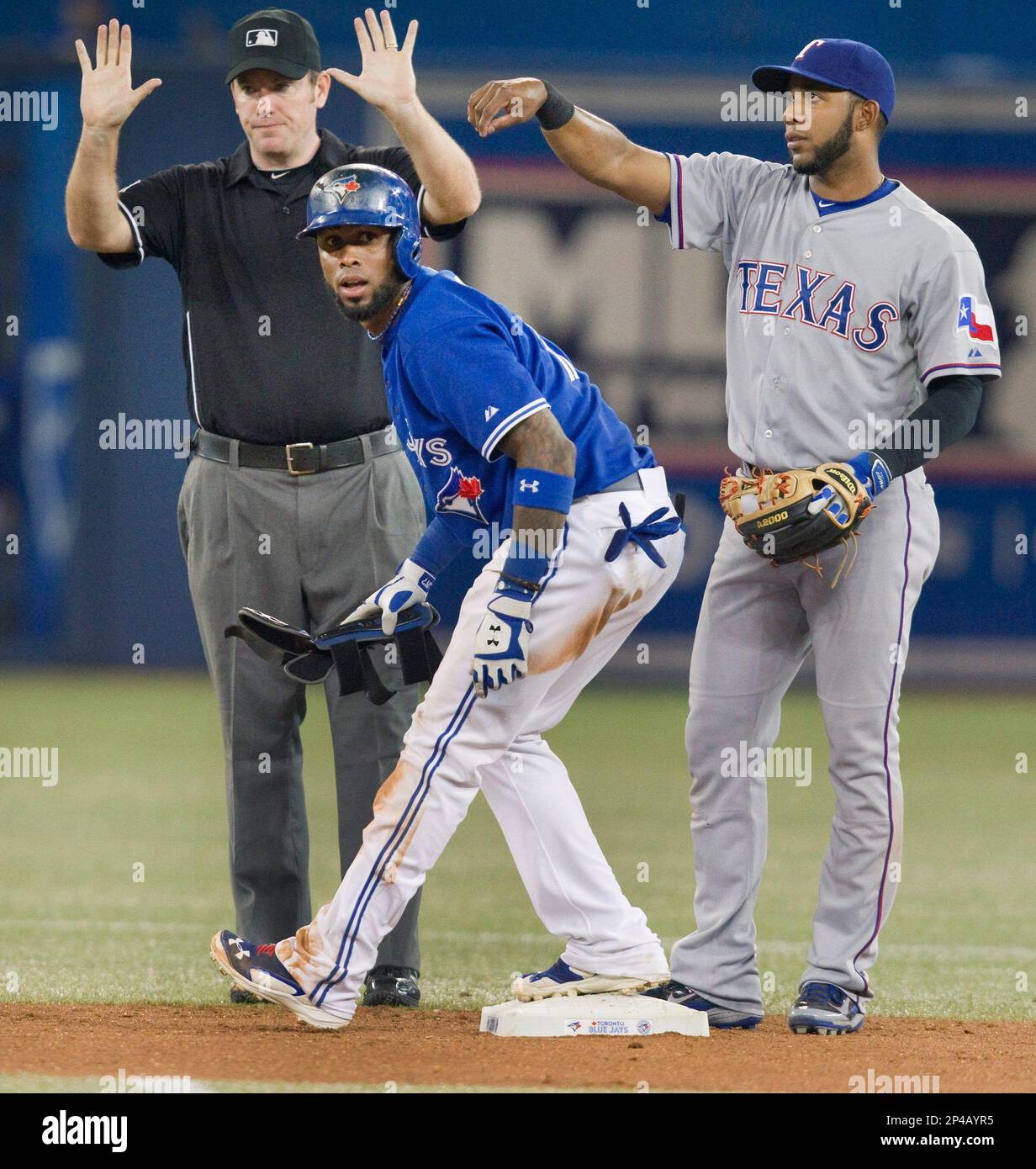 Toronto Blue Jays' Jose Reyes stands at second base after hitting a stand  up double as Texas Rangers' Elvis Andrus looks on and second base umpire  Chris Conroy calls for time during