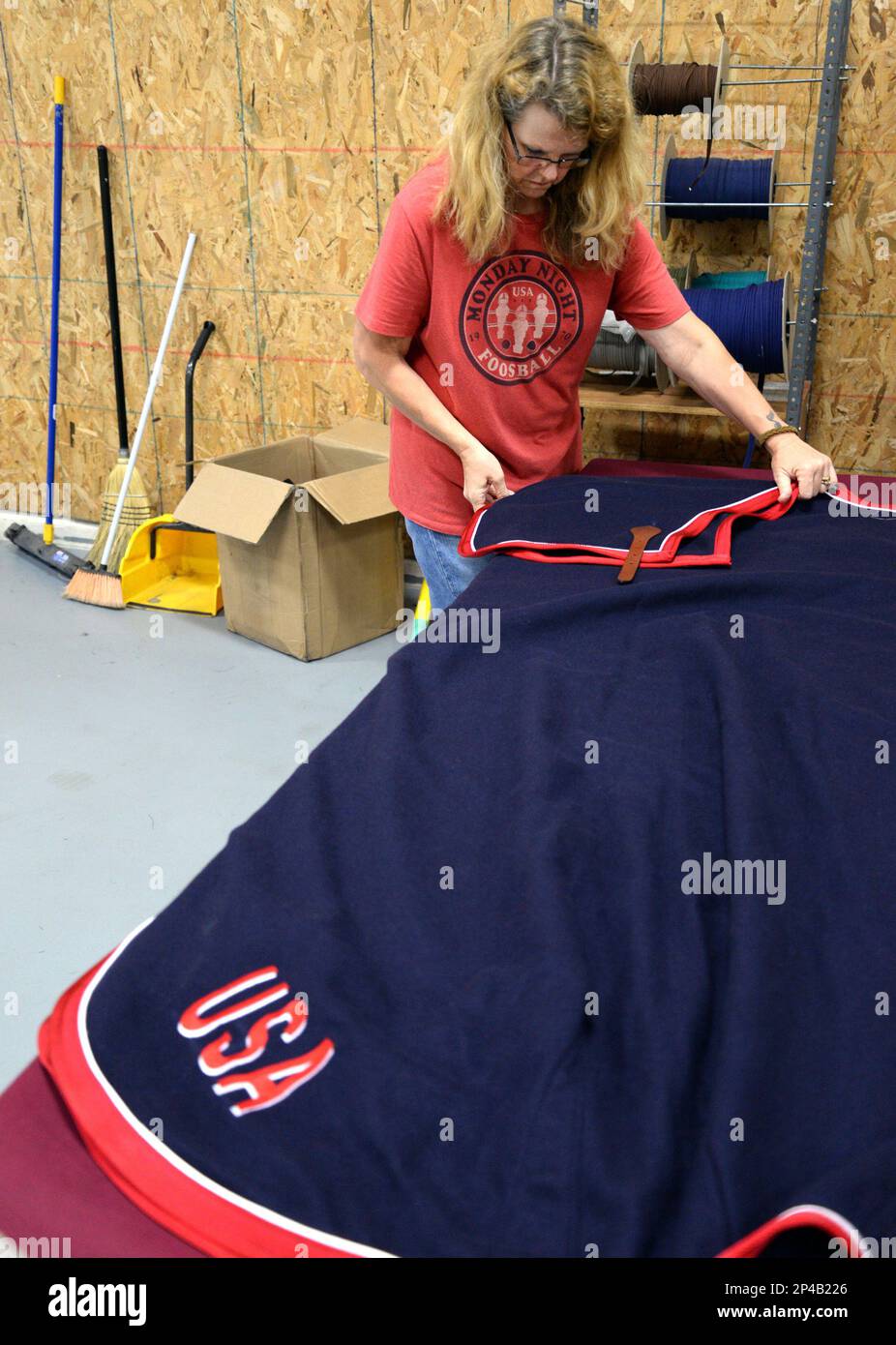 Cassy Wood folds a Triple Crown custom wool dress sheet for delivery at