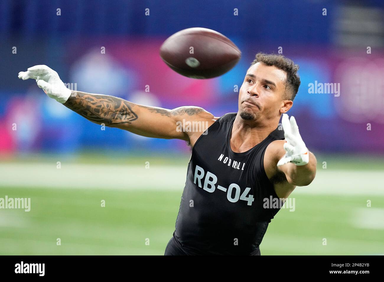 Illinois running back Chase Brown runs a drill at the NFL football