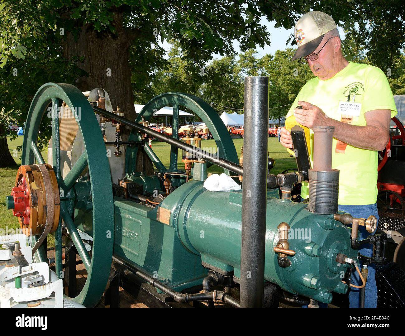 Hank Tomey, of Washington, Ind., tops off the oil in his antique Hit