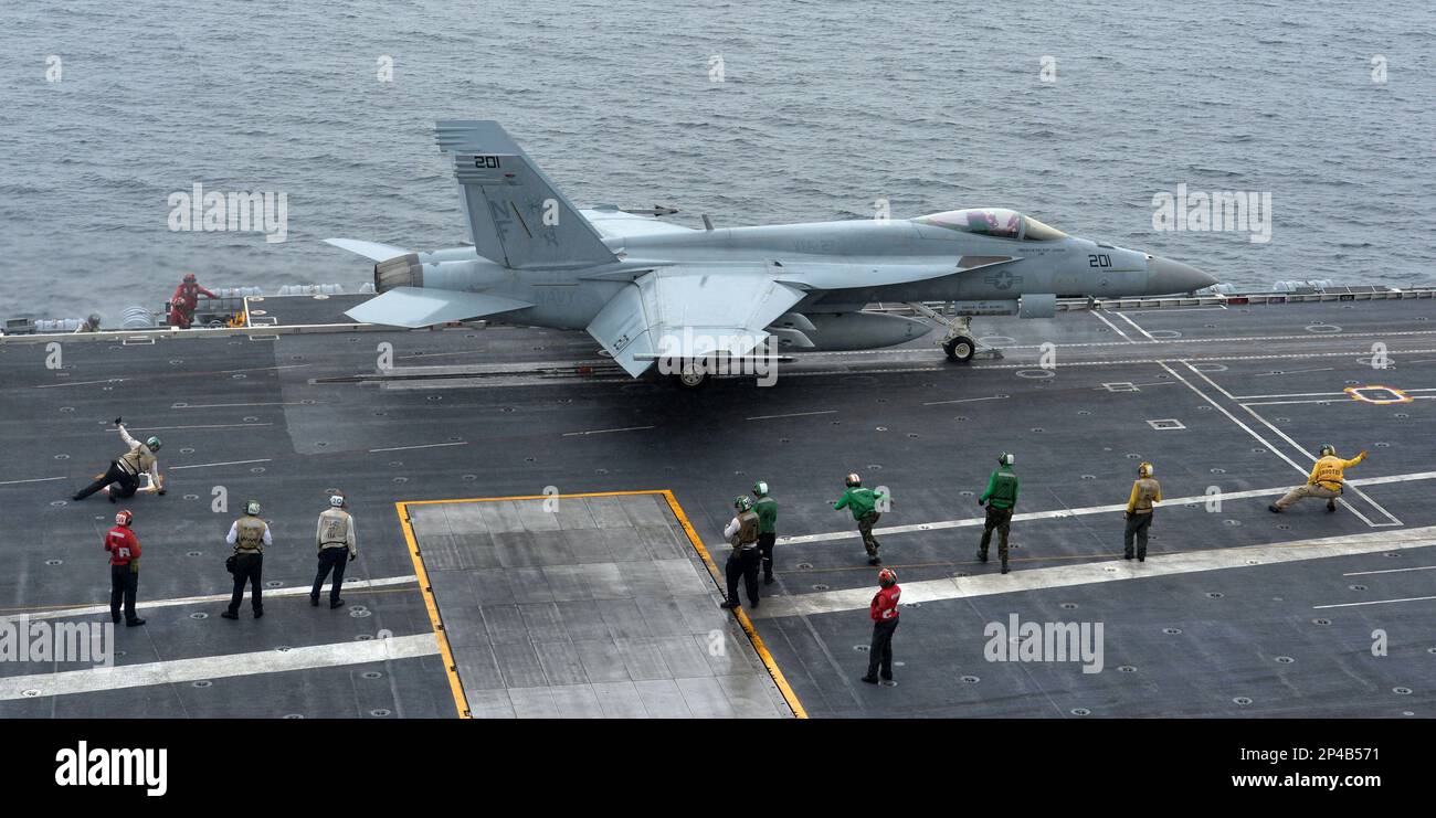 A U.S. F18 Hornet fighter attack aircraft is launched off the deck of ...