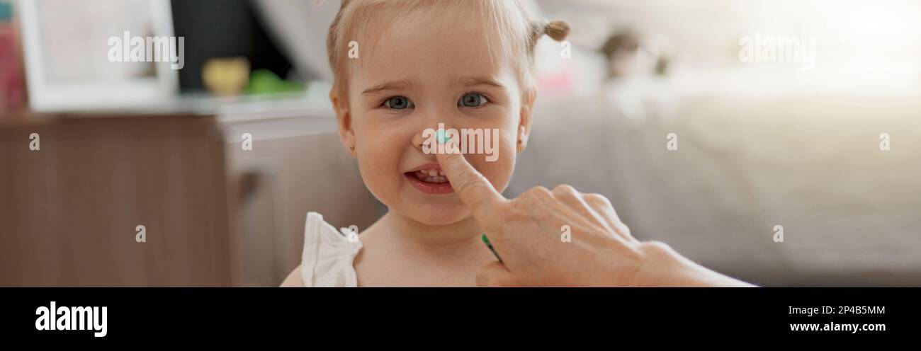 Little smiling girl painting with her mother at home while spending ...