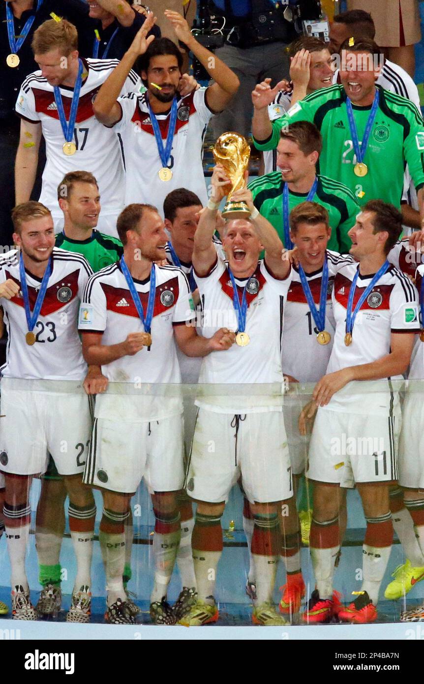 Germany s Bastian Schweinsteiger Holds Up The Trophy As The German Team germany-s-bastian-schweinsteiger-holds-up-the-trophy-as-the-german-team