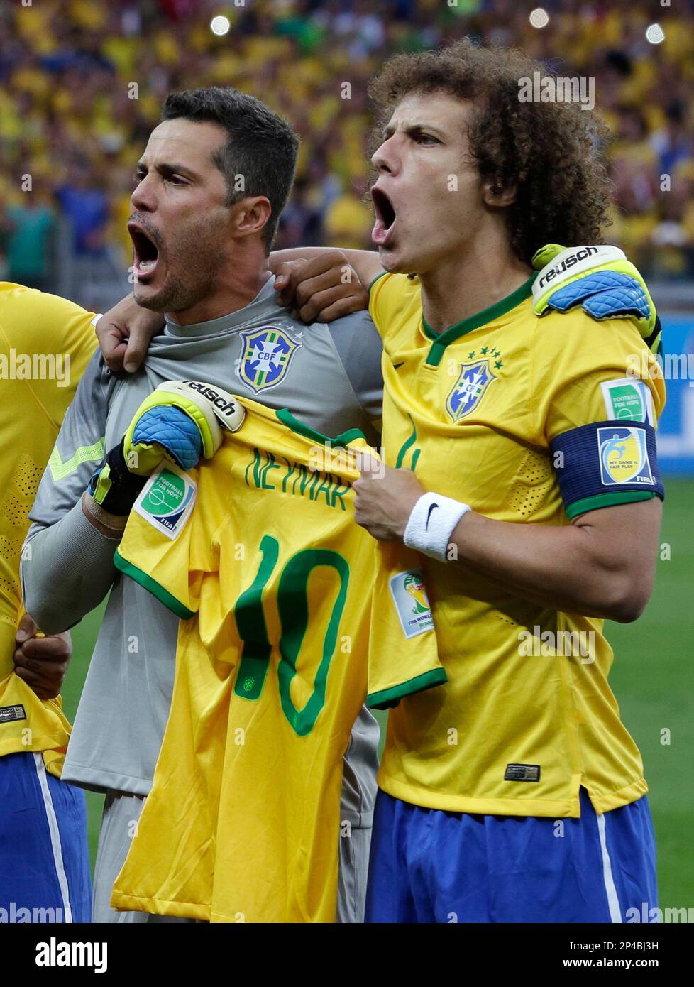 Brazil's David Luiz, right, and goalkeeper Julio Cesar hold up the team  jersey of injured Brazilian star Neymar as they sing the anthem before the  World Cup semifinal soccer match between Brazil
