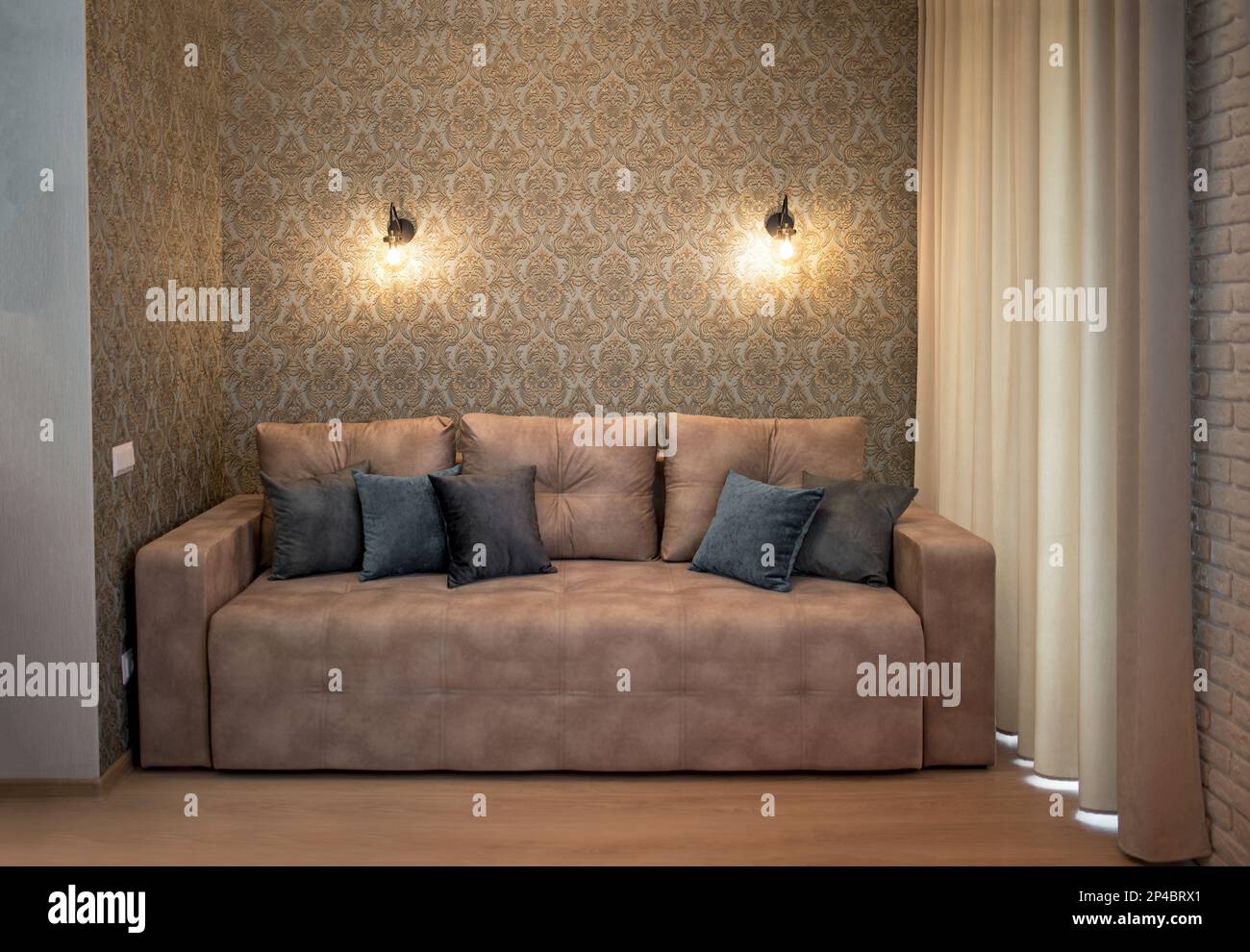 open plan living room and kitchen interior with gray sofa with cushions