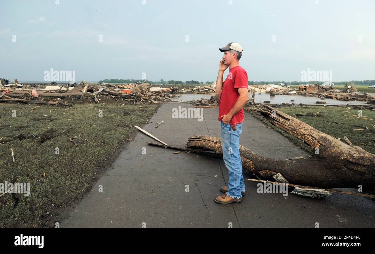 Brian Reeg of Winside talks on his phone as he stands on the sidewalk