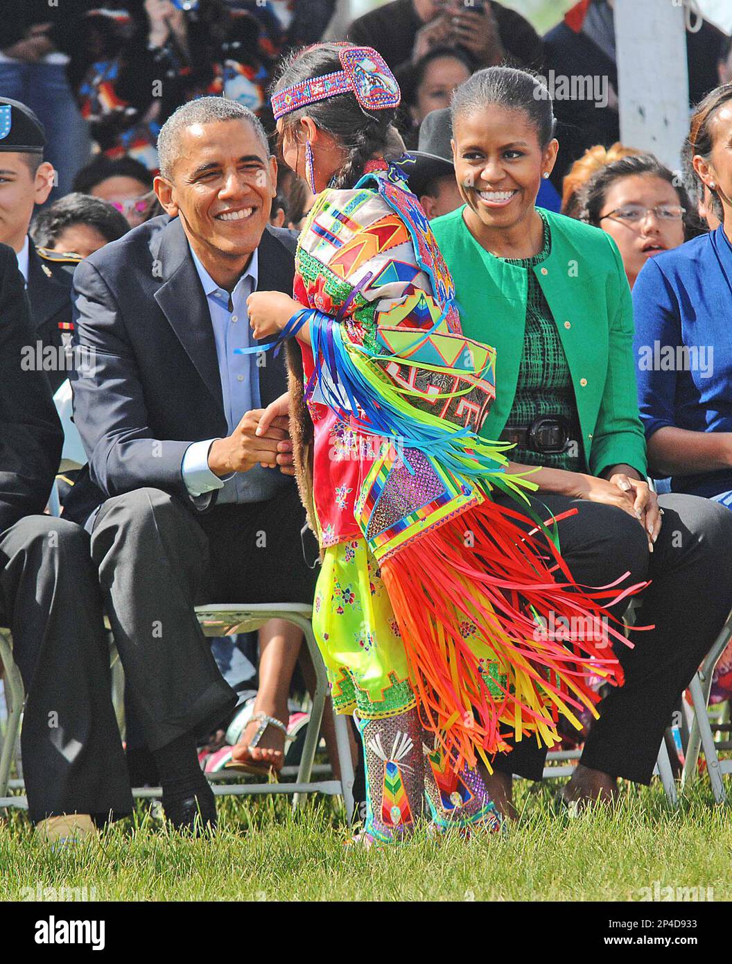 President Barack Obama and first lady Michelle Obama greet a young ...
