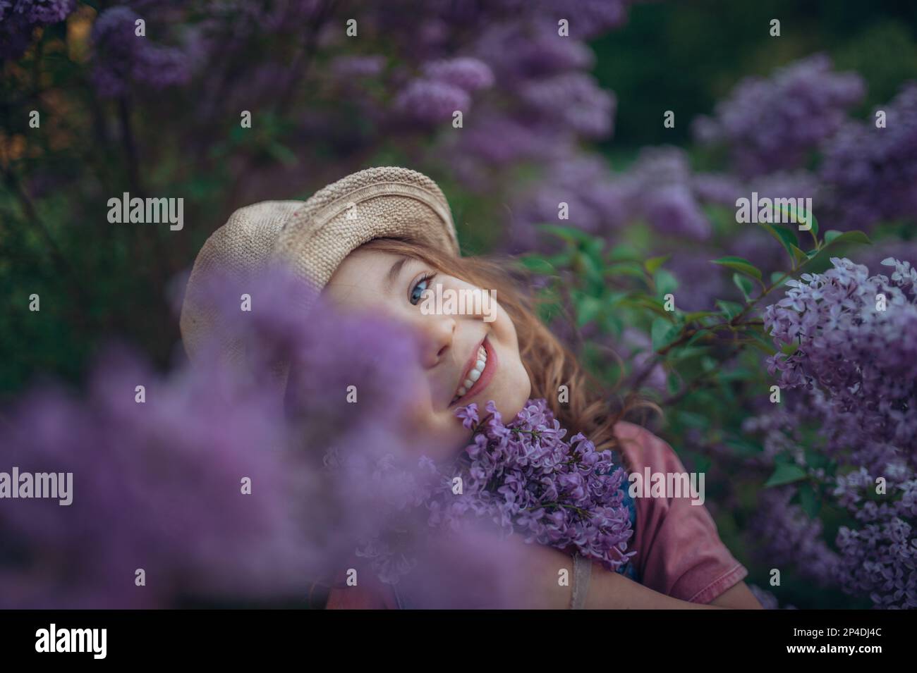 Portrait of little girl with lilac, spring mood Stock Photo - Alamy