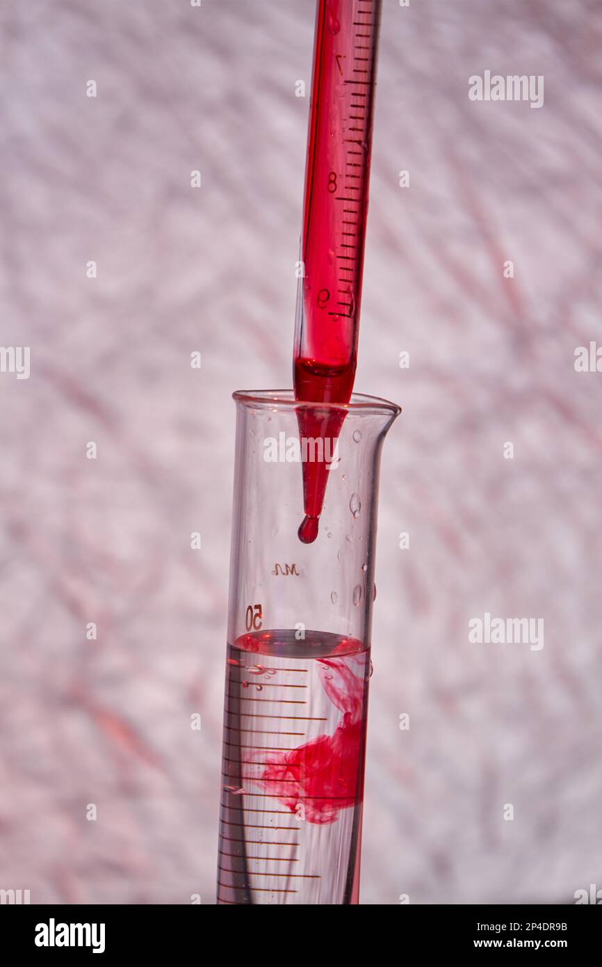 Close up pipette dropping blood into test tube. Blood test and analysis