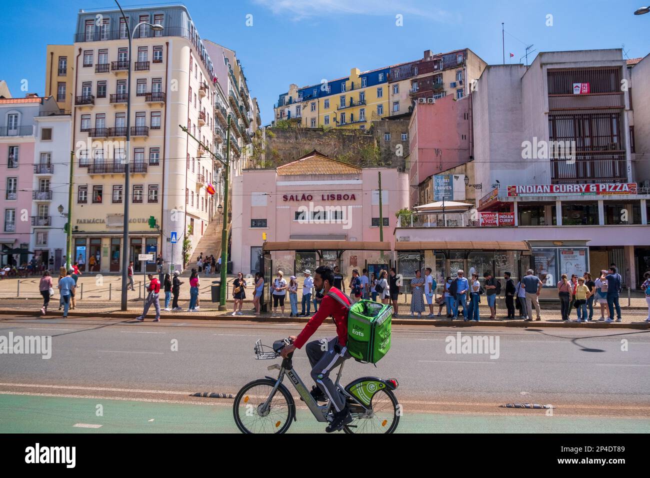 An Uber Eats deliver driver on a bicycle in Lisbon, Portugal Stock Photo
