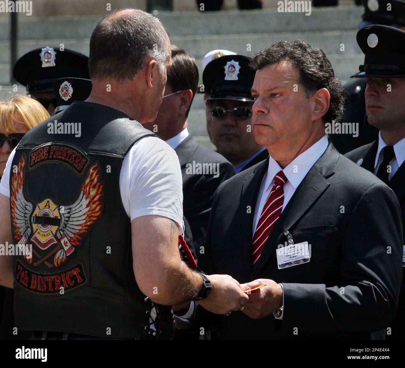 Greg Nejmeh receives a ribbon from the Firefighters 7th District