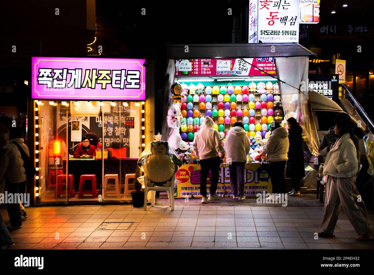 Balloon popping darts game arcade and fortune teller shop at Haeundae street night market for korean people travelers travel visit and playing use ser Stock Photo