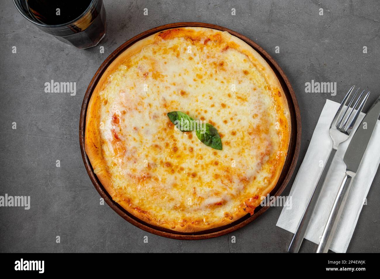 Italian pizza with four cheeses and lots of mozzarella on a cutting