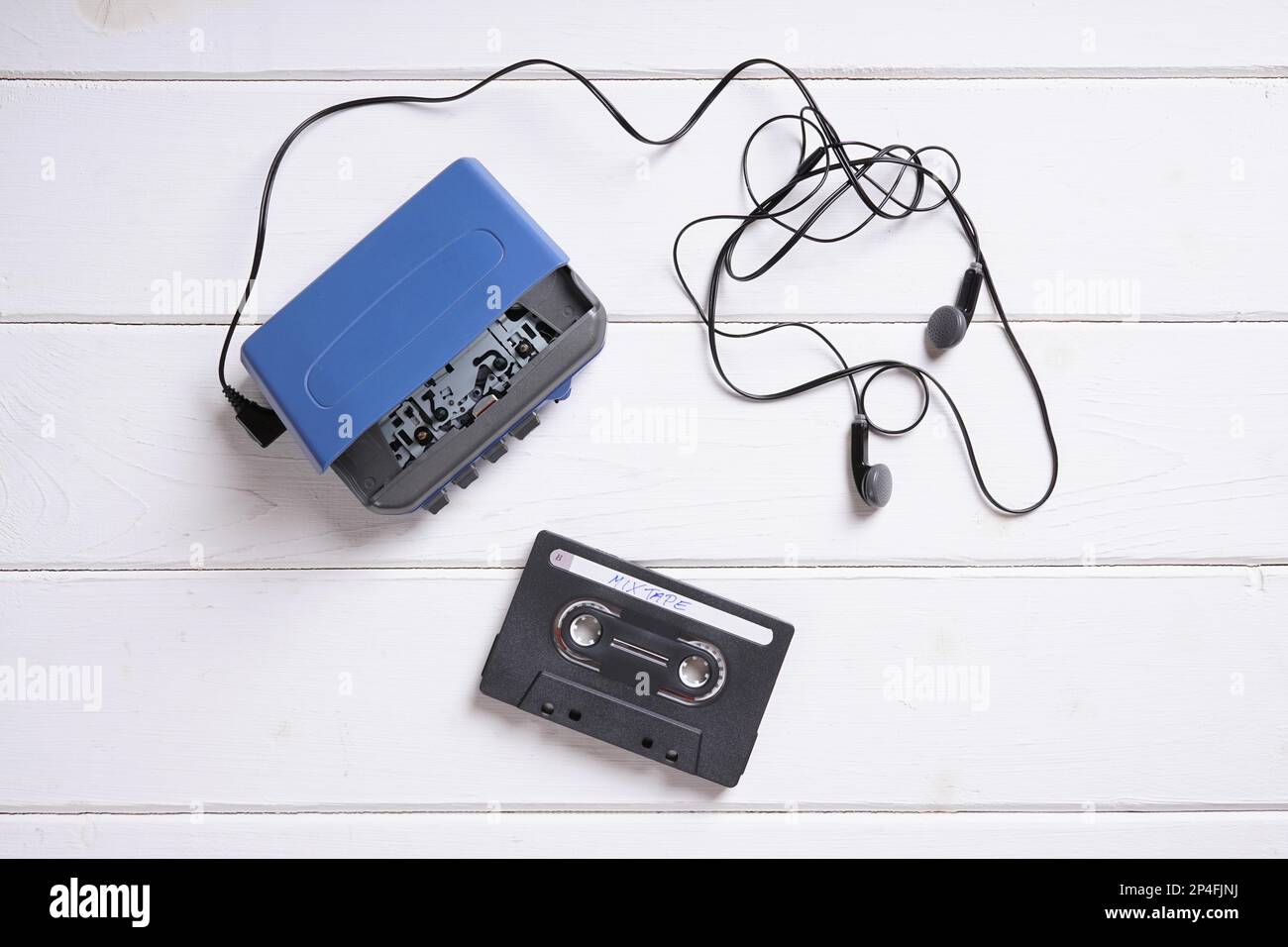 vintage walkman or cassette player with earbuds and mix tape Stock Photo
