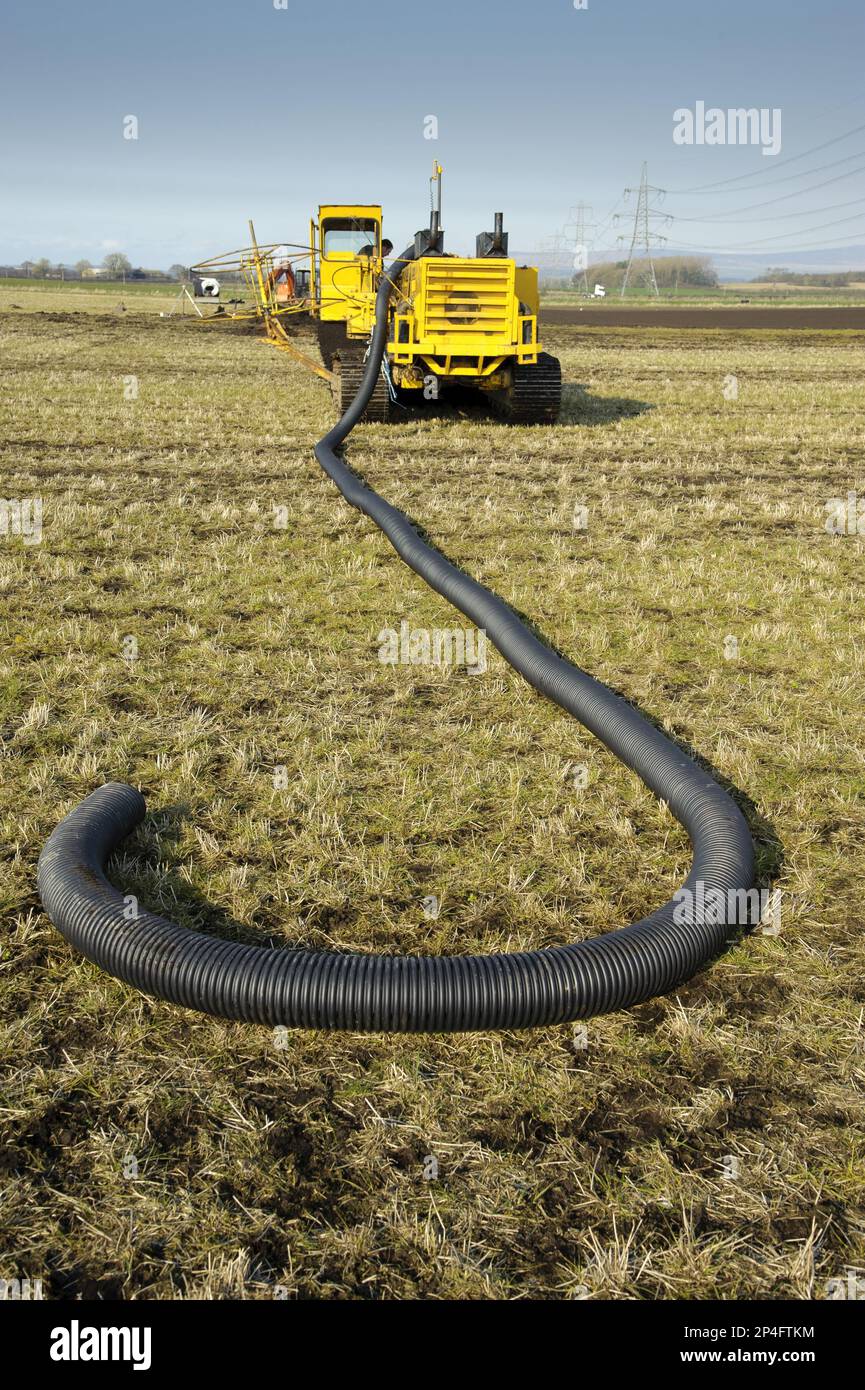 Field drainage, continuous pipe laying machine working in arable field