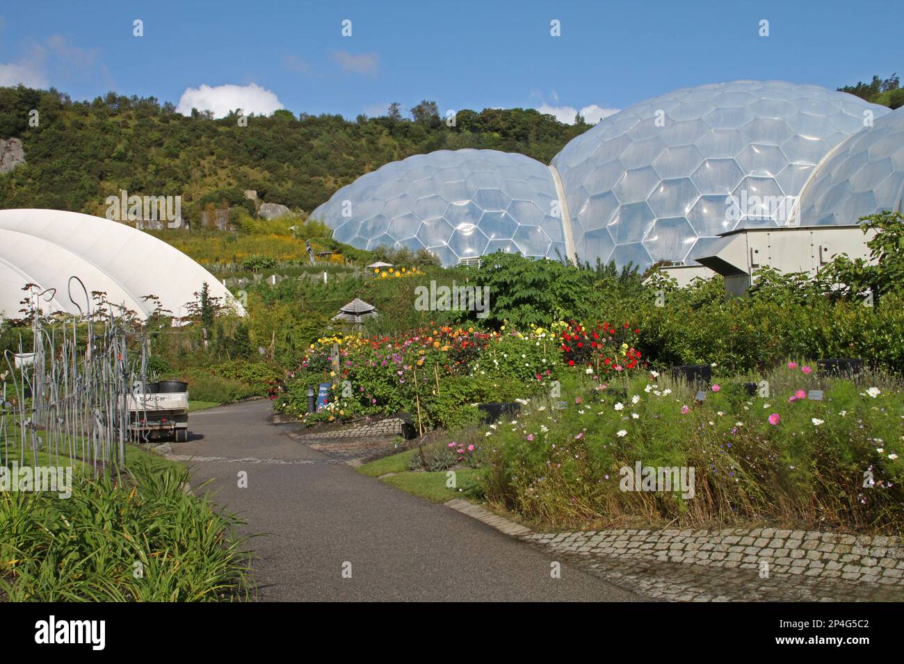 View of the flower beds and the outside of the biomes, Eden Project, Cornwall, England, United Kingdom Stock Photo