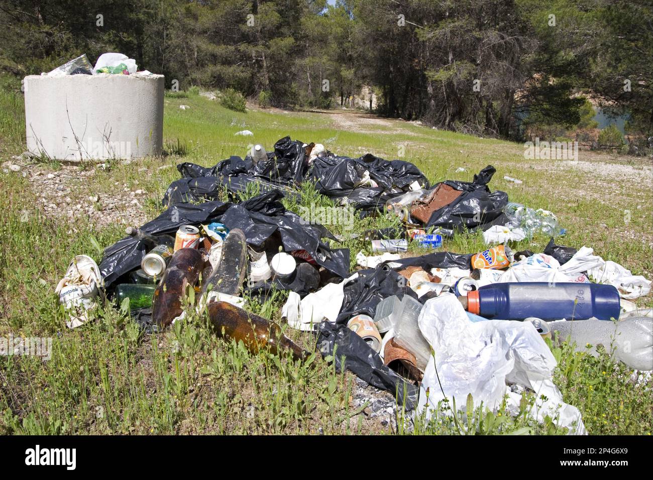 Litter in black plastic bags, tourist rubbish dumped in beauty spot
