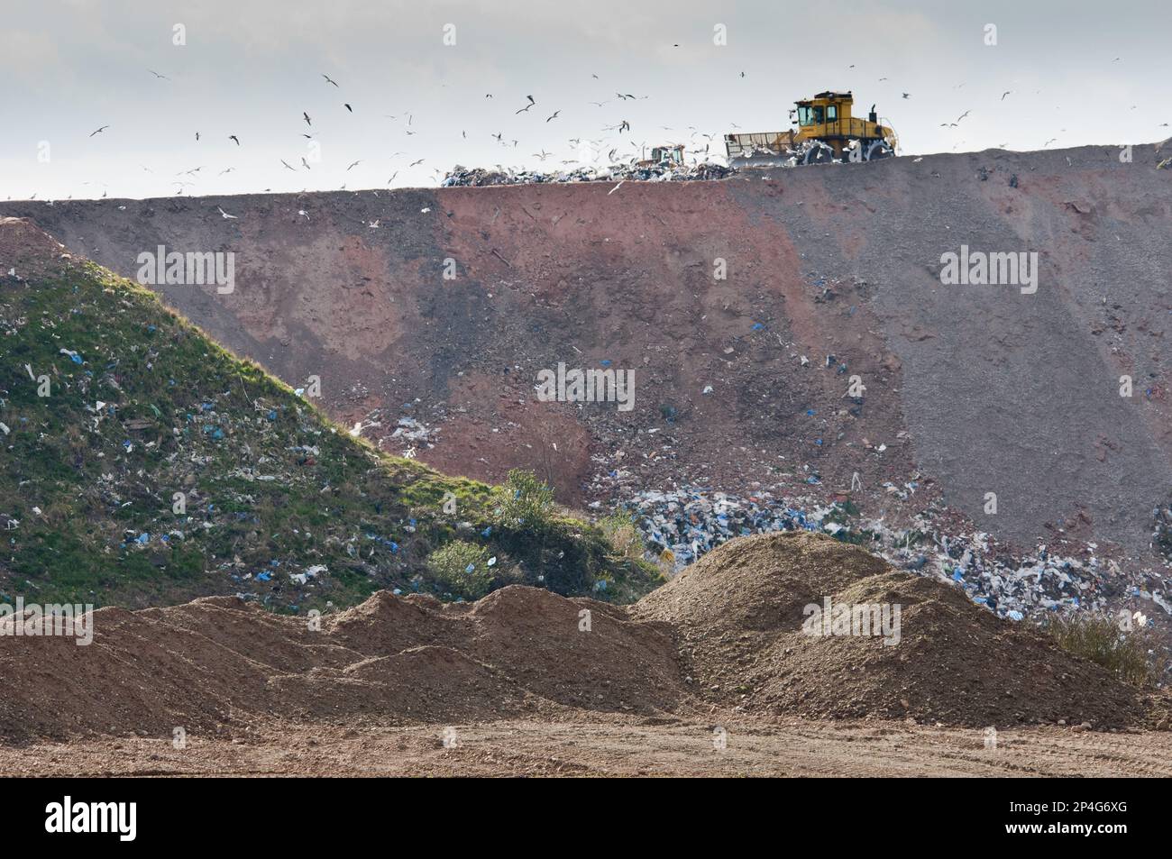 Compaction machines working on council rubbish tip, near Ellesmere, Cheshire, England, United Kingdom Stock Photo