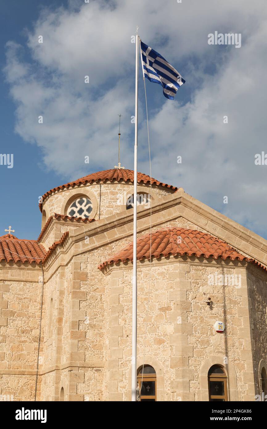 Cyprus, Cape Drepano, the greek orthodox church - Agios Georgios and greek national flag. Stock Photo