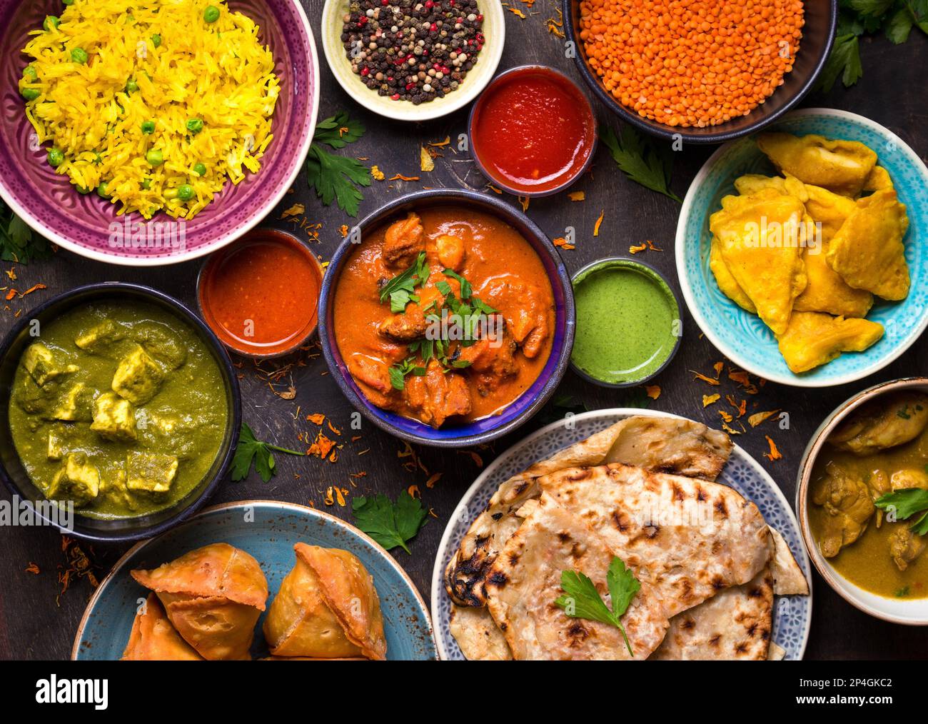Assorted indian food on dark wooden background. Dishes and appetizers