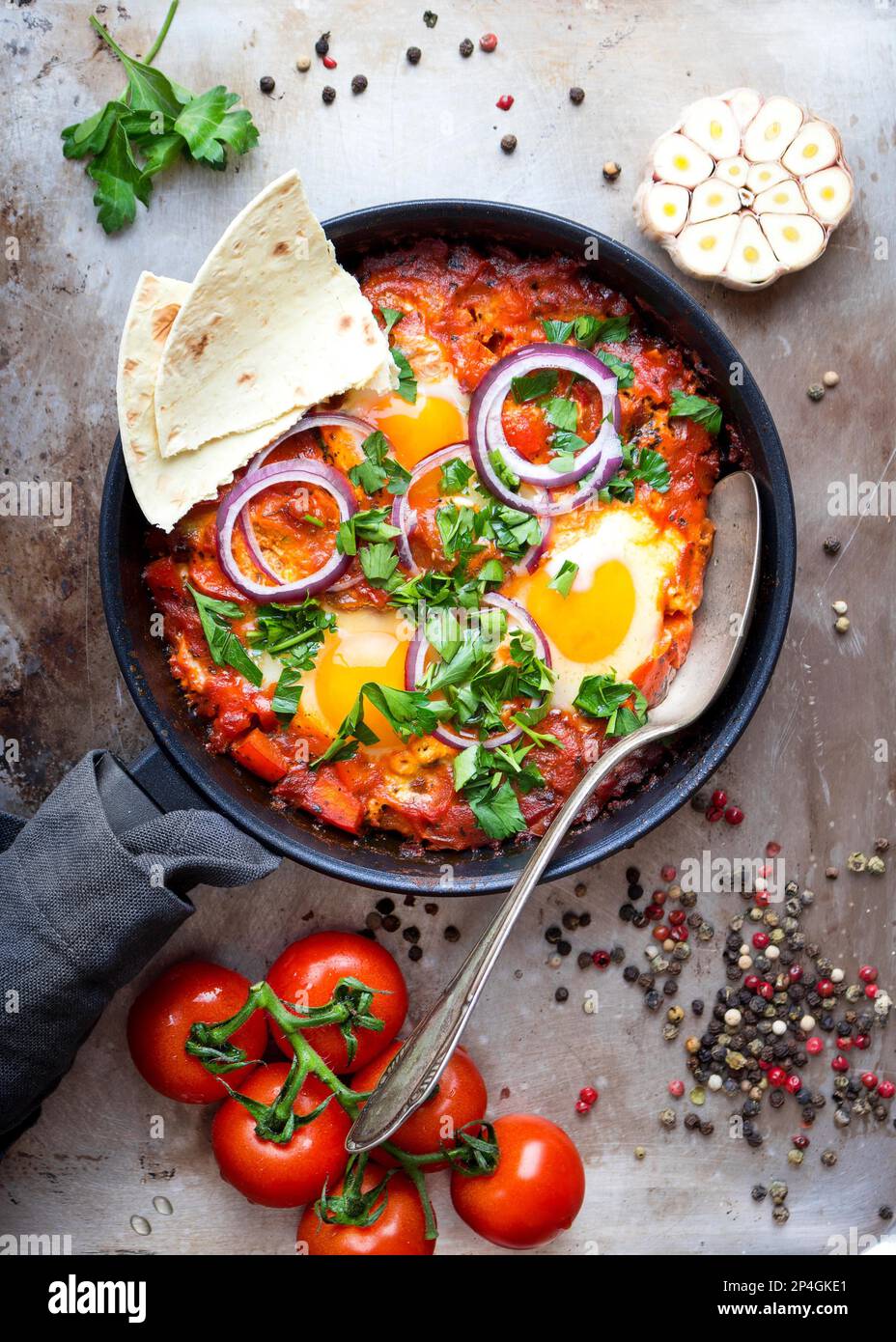 Shakshuka with pita bread in a pan. Middle eastern traditional dish