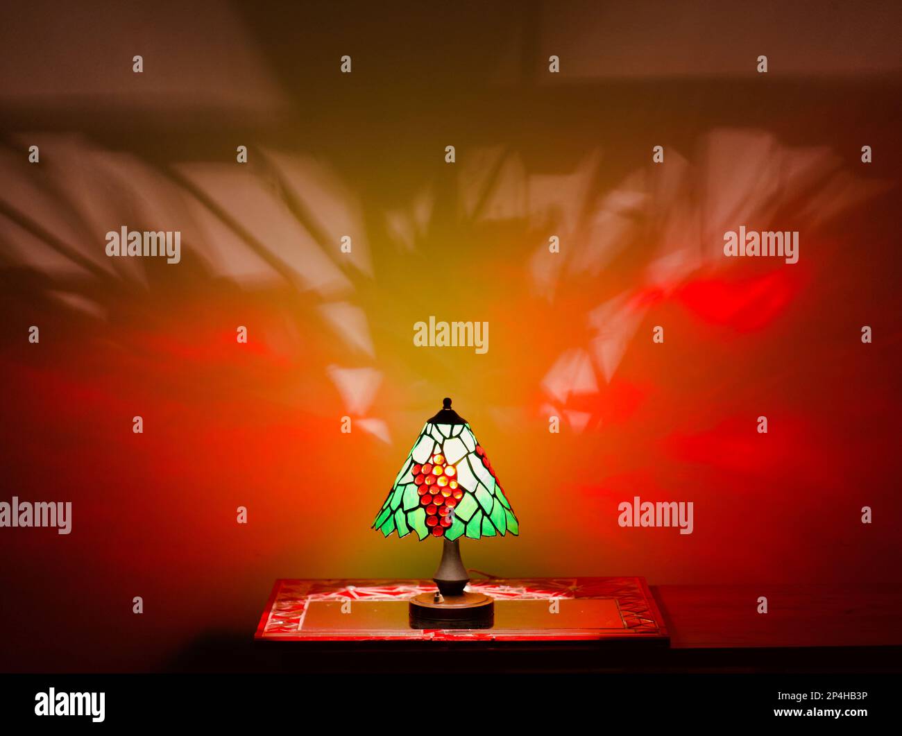 Stained Glass Lamp with Orange Fire Shadow Stock Photo Alamy