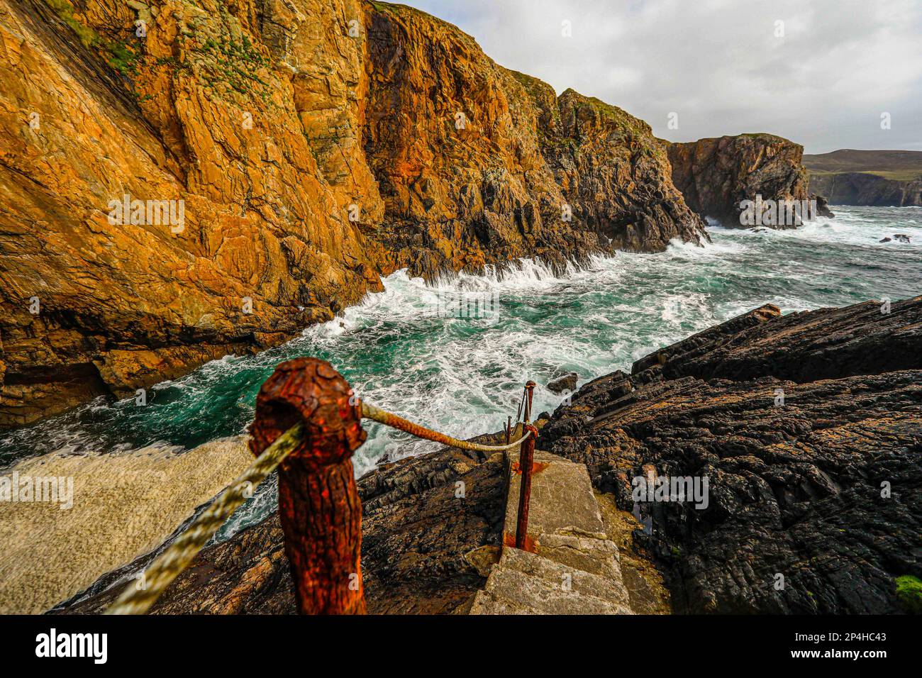 Steps down to roaring waves in Ireland Stock Photo