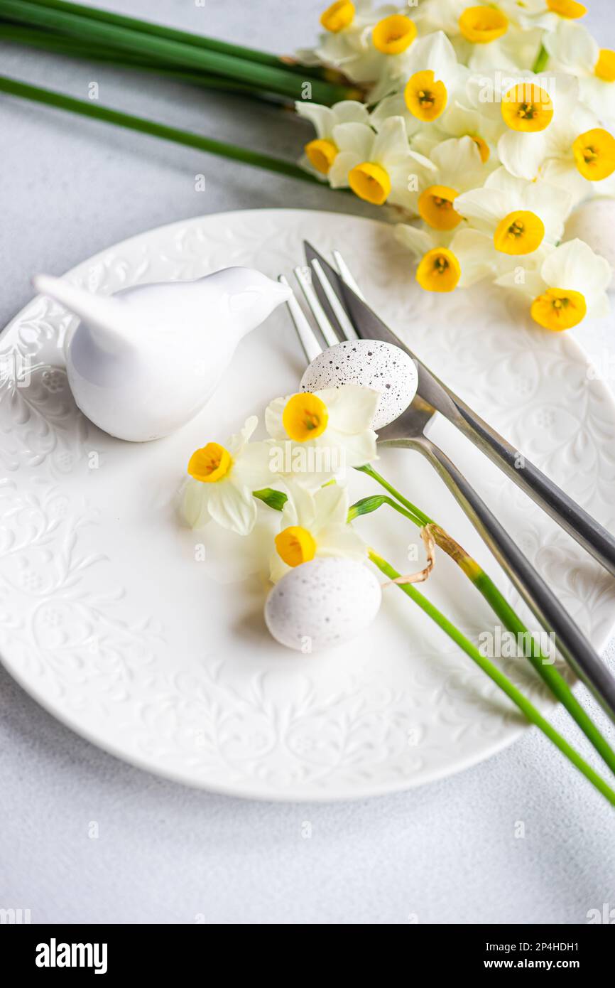 Spring table setting with daffodils Stock Photo