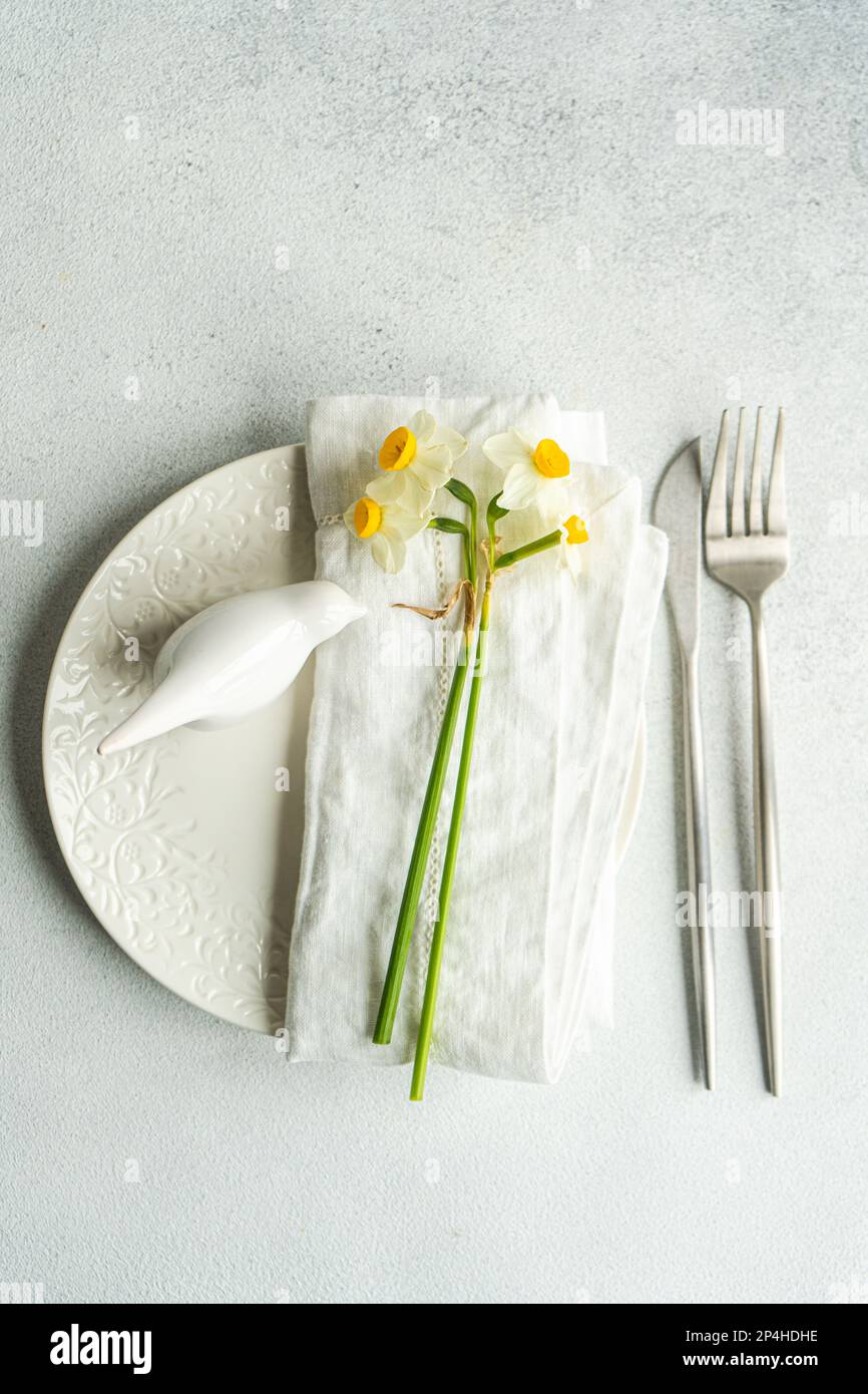 Spring table setting with daffodils Stock Photo