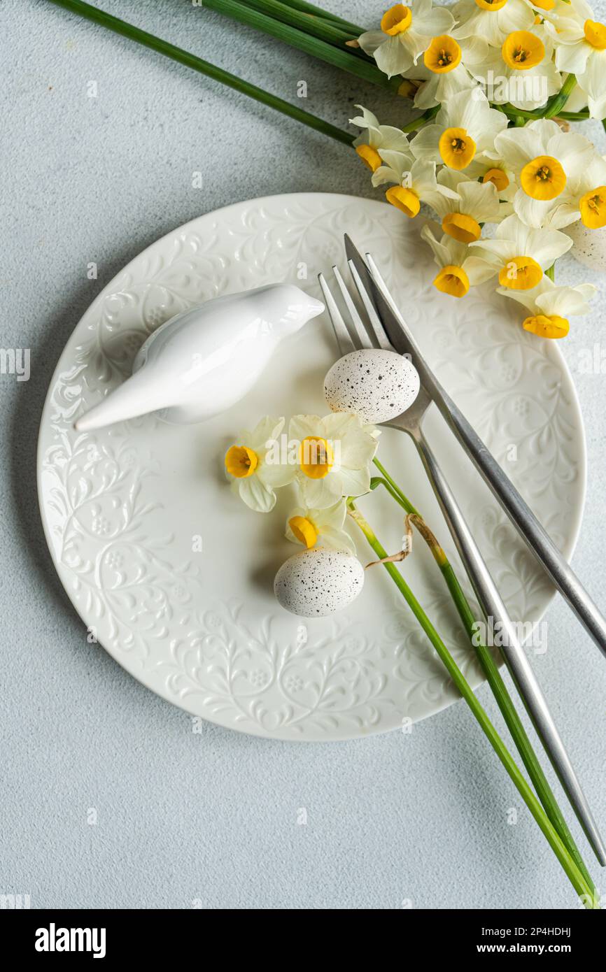 Spring table setting with daffodils Stock Photo