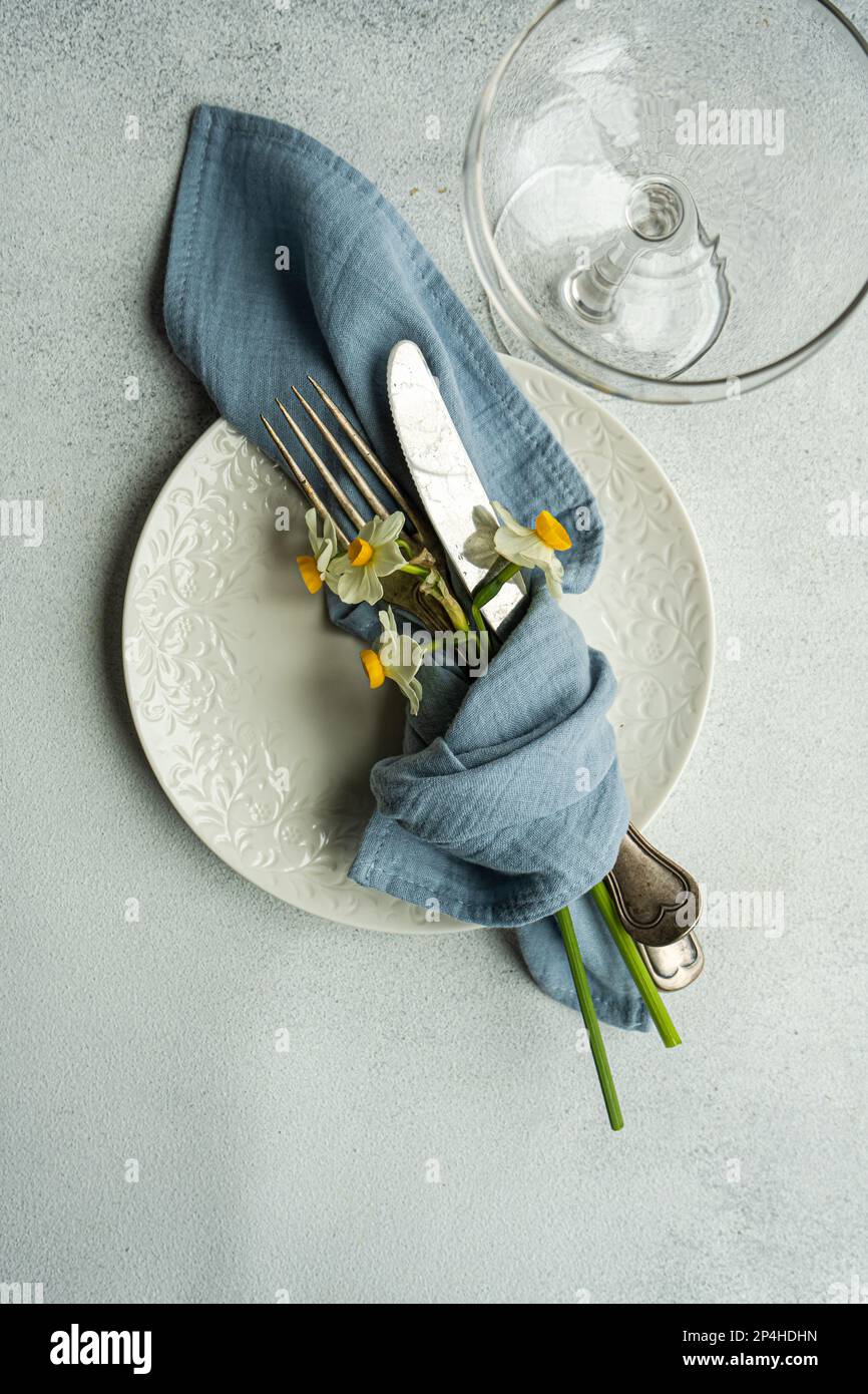 Spring table setting with daffodils Stock Photo