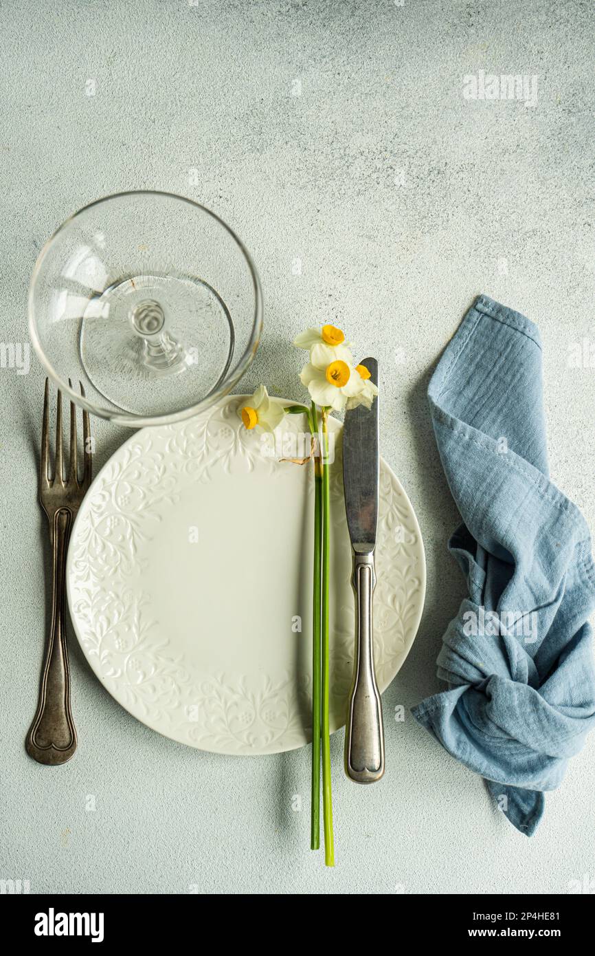 Spring table setting with daffodils Stock Photo