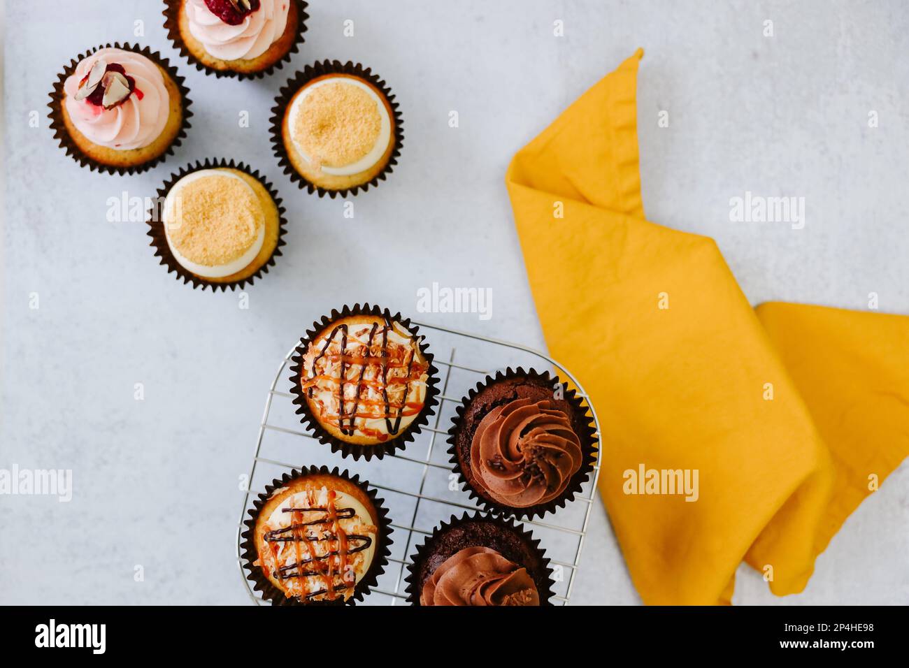Delicious cupcakes on cooling rack with yellow napkin Stock Photo - Alamy